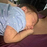 Annalise is registered to the contest to win money with this photo: baby, newborn, sleeping, infant, blue_onesie, polka_dots, arm, person, skin, closeup, resting, peaceful, cozy, cuddle, human, child, sleep, face, head, parent