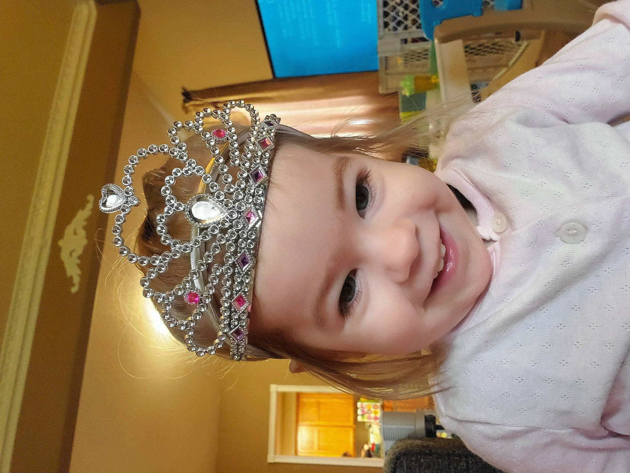 Hylia is registered to the contest to win money with this photo: baby_toddler_clothing, cheek, child, eyelash, fashion_accessory, fun, happy, hat, headwear, joy, nose, person, room, smile, toddler, wood