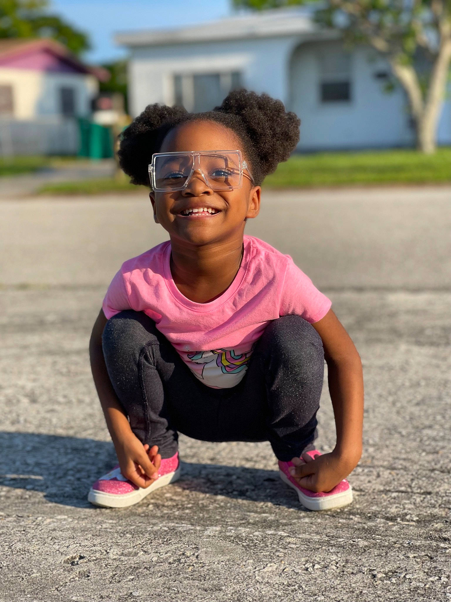 Cyan is registered to the contest to win money with this photo: asphalt, child, eyewear, fun, grass, happy, head, joy, leisure, magenta, people_in_nature, person, pink, plant, recreation, sitting, smile, soil, summer, temple