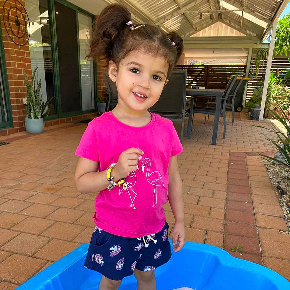 Aisha joined the competition — help win amazing prizes! active_shorts, backyard, child, door, ear, flowerpot, fun, hair_accessory, houseplant, joy, magenta, majorelle_blue, outdoor_furniture, outdoor_structure, outdoor_table, person, pink, plastic, play, shade