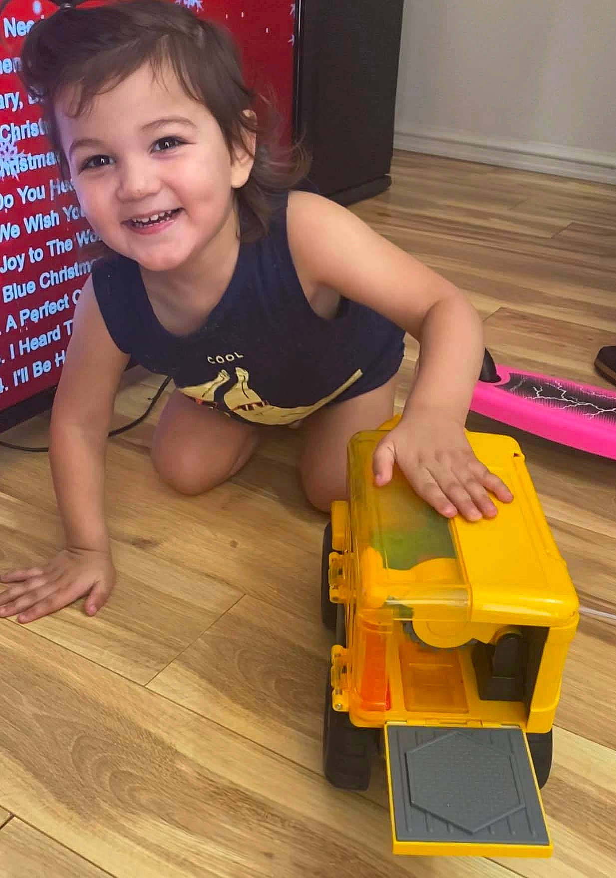 Taj is registered to the contest to win money with this photo: baby_playing_with_toys, baby_toddler_clothing, baby_toys, child, finger, floor, flooring, fun, hardwood, joy, laminate_flooring, mouth, person, plastic, play, plywood, toddler, toy, varnish, wood
