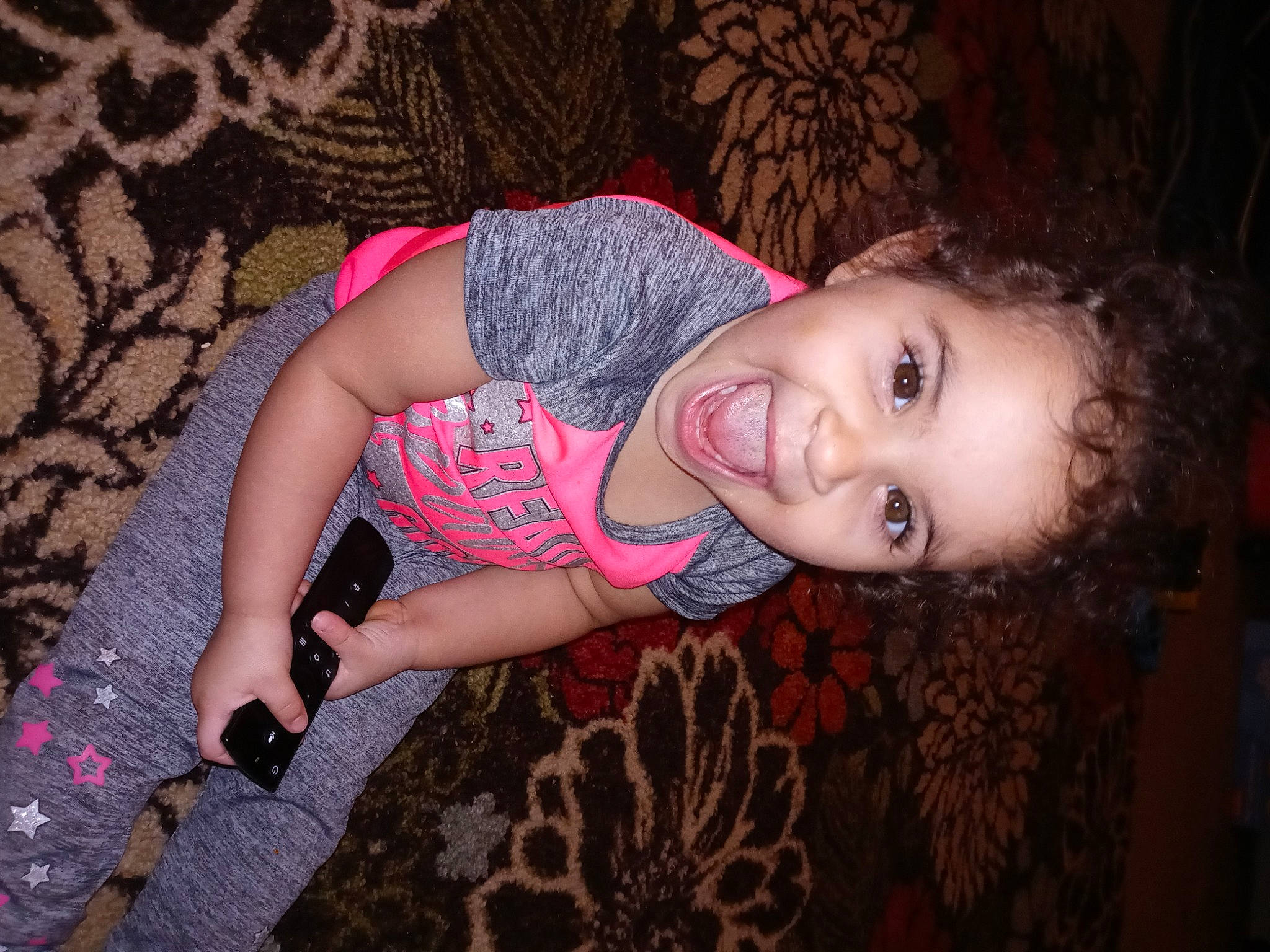 Ansleigh is registered to the contest to win money with this photo: beauty, black_hair, cheek, child, eye, fawn, fun, human, lip, long_hair, mouth, nose, pattern, person, photography, pink, sitting, skin, smile