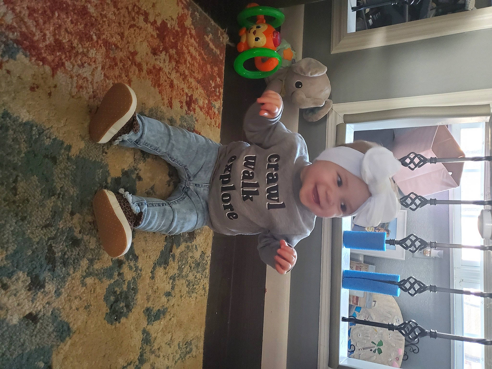 Makenzie is registered to the contest to win money with this photo: child, flooring, fun, hat, headwear, joy, landscape, leisure, person, room, soil, standing, stuffed_toy, t_shirt, toddler, toy, wood, world