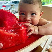 Katalina joined the competition — help win amazing prizes! baby, child, watermelon, food, fruit, high_chair, juice, hand, face, outdoor, summer, greenery, car, seat, cheeks, cute, eating, messy, closeup, happy