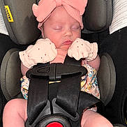 Elizabeth is registered to the contest to win money with this photo: baby, sleeping, car_seat, pink_bow, mittens, infant, child, safety_harness, cute, newborn, closeup, portrait, child_seat, soft_lighting, peaceful, indoor, clothing, face, headwear, resting