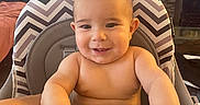 Julian joined the competition — help win amazing prizes! baby, child, high_chair, smiling, indoor, zigzag_pattern, arm, face, curious, furniture, exercise_ball, tiled_wall, person, skin, seat, table, home, cute, happy, young