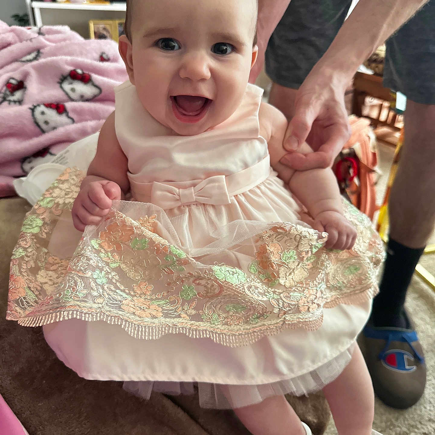 Hezekeirah is registered to the contest to win money with this photo: adult, baby, clothing, dress, face, footwear, happy, head, male, man, pants, person, photoframe, photography, portrait, sandal, shoe, sitting, skirt, sneaker