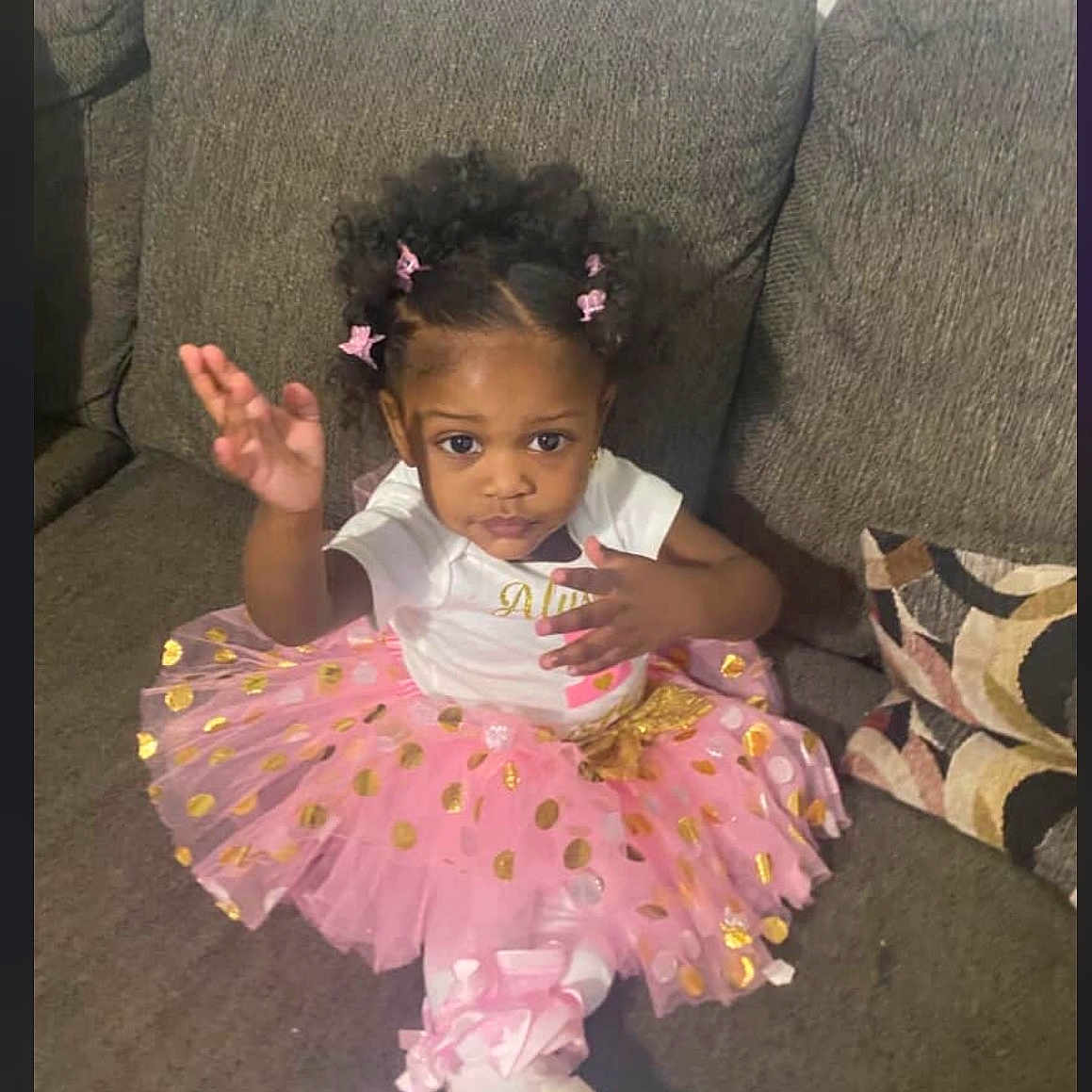 Alysia Span is registered to the contest to win money with this photo: child, couch, curly_hair, cushion, cute, fashion, girl, golden_polka_dots, gray_couch, hair_clips, home, indoor, pink_tutu, playful_pose, portrait, sitting, toddler, white_shirt, white_shoes, young_child