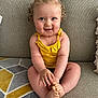Alba a rejoint le concours — aidez-le/la à gagner de superbes lots ! baby, child, cute, smiling, curly_hair, yellow_top, sitting, couch, indoor, cross_legged, happy, portrait, infant, person, skin, furniture, cozy, plush, head, hands