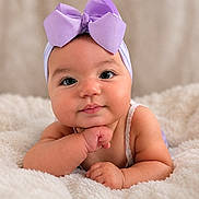Flavia joined the competition — help win amazing prizes! baby, infant, child, portrait, face, eyes, bow, headband, lavender, smiling, cute, sitting, blanket, fluffy, indoors, close_up, hands, arms, photography, adorable