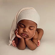 Karl is registered to the contest to win money with this photo: baby, sleeping, infant, child, hat, hands, feet, skin, peaceful, portrait, closeup, neutral_background, soft_lighting, cute, newborn, resting, chubby_cheeks, cozy, calm, toddler