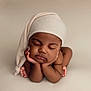 baby, sleeping, infant, child, hat, hands, feet, skin, peaceful, portrait, closeup, neutral_background, soft_lighting, cute, newborn, resting, chubby_cheeks, cozy, calm, toddler