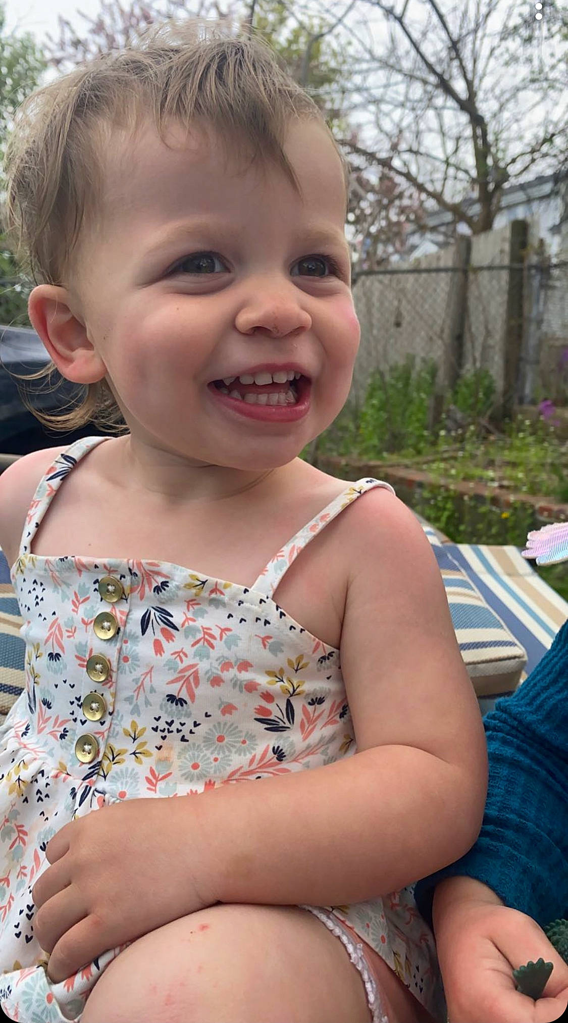 Eliana is registered to the contest to win money with this photo: blond, cheek, child, chin, eye, face, facial_expression, fun, grass, happy, human_body, iris, leisure, person, plant, skin, smile, summer, thigh, toddler