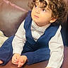 Ayhan Sharifi is registered to the contest to win money with this photo: child, toddler, curly_hair, portrait, sitting, couch, bow_tie, formal_clothing, navy_outfit, white_shirt, looking_up, serious_expression, indoor, furniture, hands, barefoot, baby, family_photo, close_up, photography