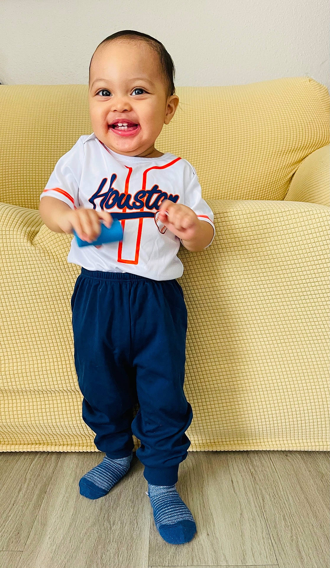 Benjamin is registered to the contest to win money with this photo: architecture, building, clothing, couch, cushion, face, furniture, happy, head, homedecor, hosiery, indoors, jeans, livingroom, pants, person, photography, portrait, sitting, sock