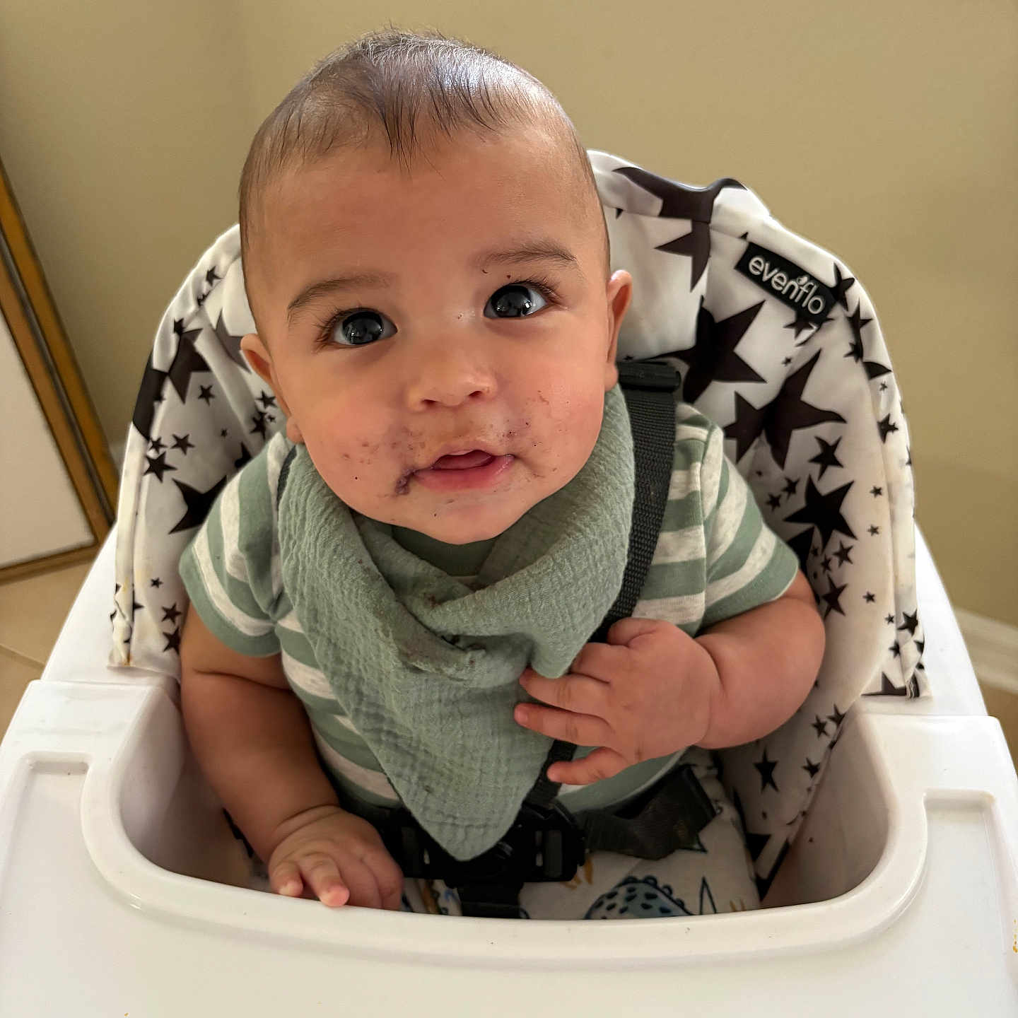 Kazimir joined the competition — help win amazing prizes! baby, bib, child, curious, cute, expression, face, feeding_time, food_smear, hands, high_chair, indoor, light, messy, person, seatbelt, striped_shirt, table, window, young_child