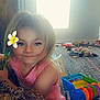 Brinley is registered to the contest to win money with this photo: bodypart, child, couch, daisy, face, female, finger, flower, flowerarrangement, furniture, girl, hand, happy, head, indoors, person, photography, plant, portrait, smile