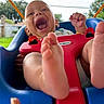 baby, child, swing, outdoor, happy, laughing, feet, hand, playful, blue, red, grass, sky, daylight, person, smile, backyard, toy, seat, fun