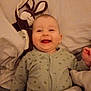 Lilio participe au concours pour gagner de l'argent avec cette photo : baby, bed, blanket, child, comfort, cozy, cute, face, happy, home, indoor, infant, lying_down, pajamas, person, plush_toy, sleepy, smiling, soft_toy, warm_lighting