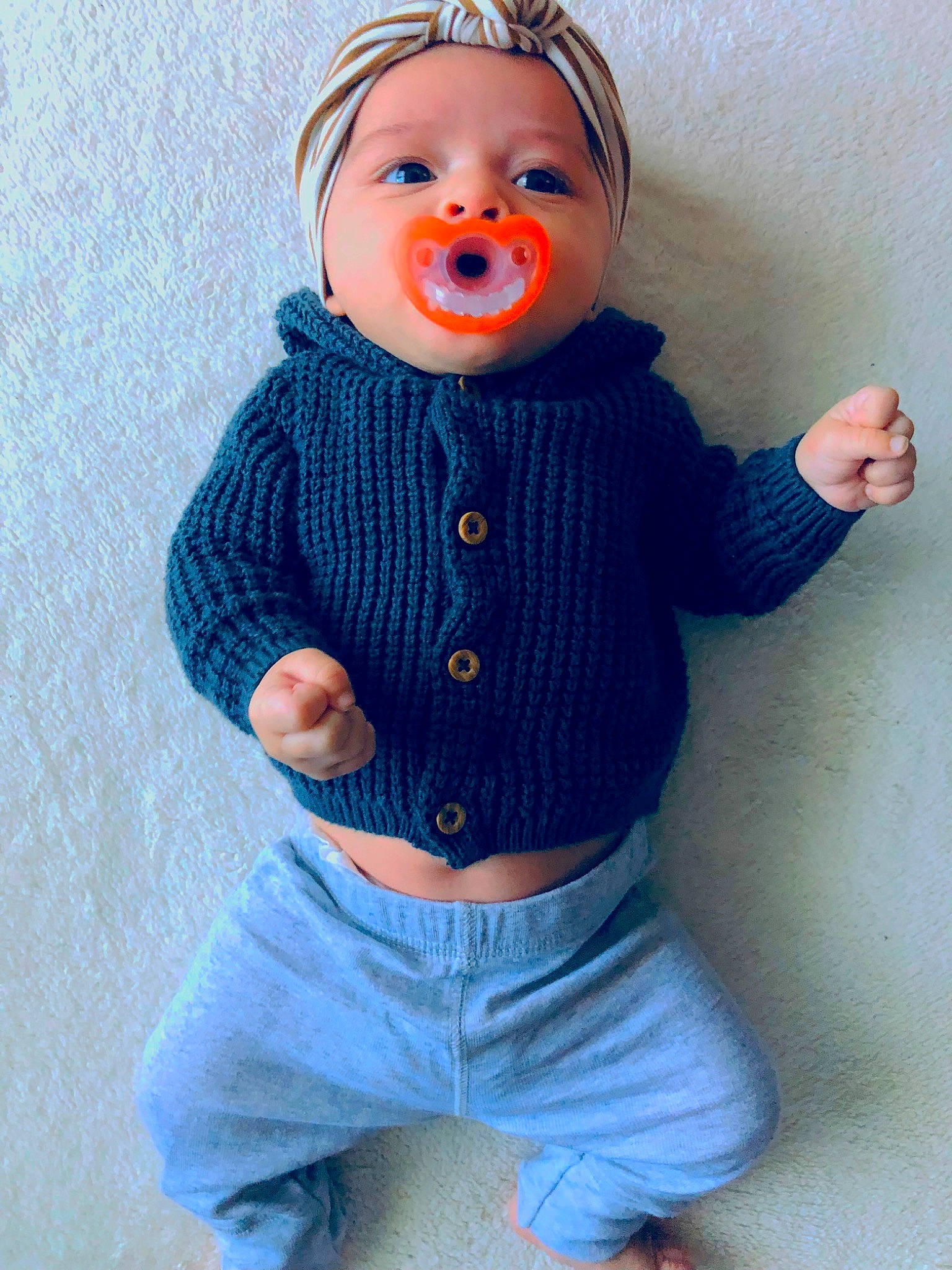 Gianna is registered to the contest to win money with this photo: arm, art, azure, baby_toddler_clothing, button, child, doll, electric_blue, hairstyle, hand, headgear, orange, pattern, person, pink, sleeve, textile, toy, waist, white