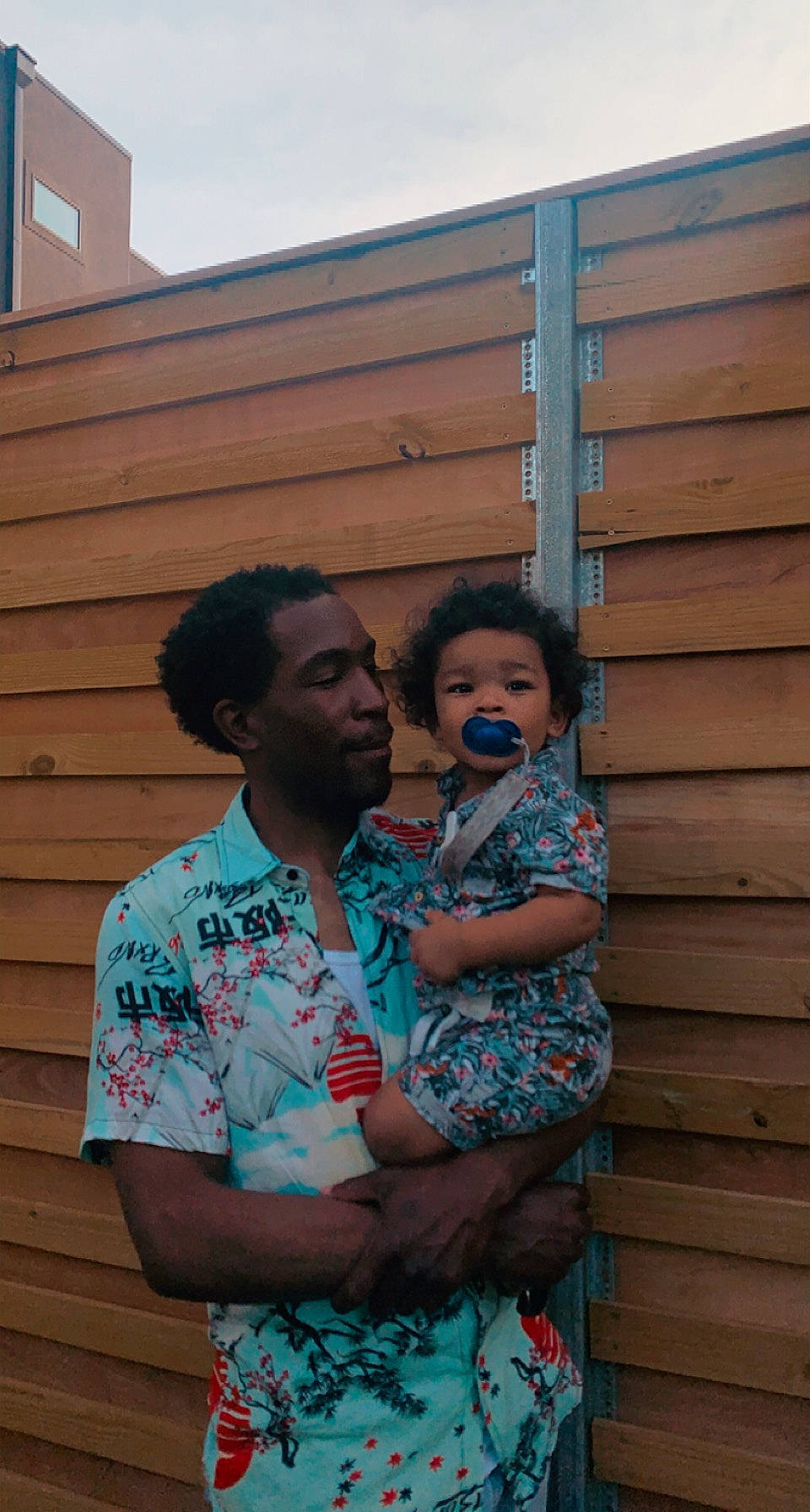 Kal-el is registered to the contest to win money with this photo: child, chin, electric_blue, event, eyewear, fun, grass, happy, house, hug, leisure, person, roof, siding, sitting, t_shirt, toddler, vacation, wood