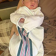 Tyler joined the competition — help win amazing prizes! newborn, baby, infant, swaddled, blanket, hat, sleeping, person, arms, plaid, fabric, striped, hospital, comfort, cozy, indoor, clothing, resting, tender, peaceful