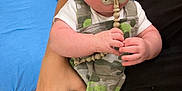 Tyler joined the competition — help win amazing prizes! baby, child, pacifier, camouflage_clothing, overalls, infant, person, holding, hand, hospital, medical_equipment, bed, footwear, floor, curious_expression, indoor, adult, skin, clothing, furniture