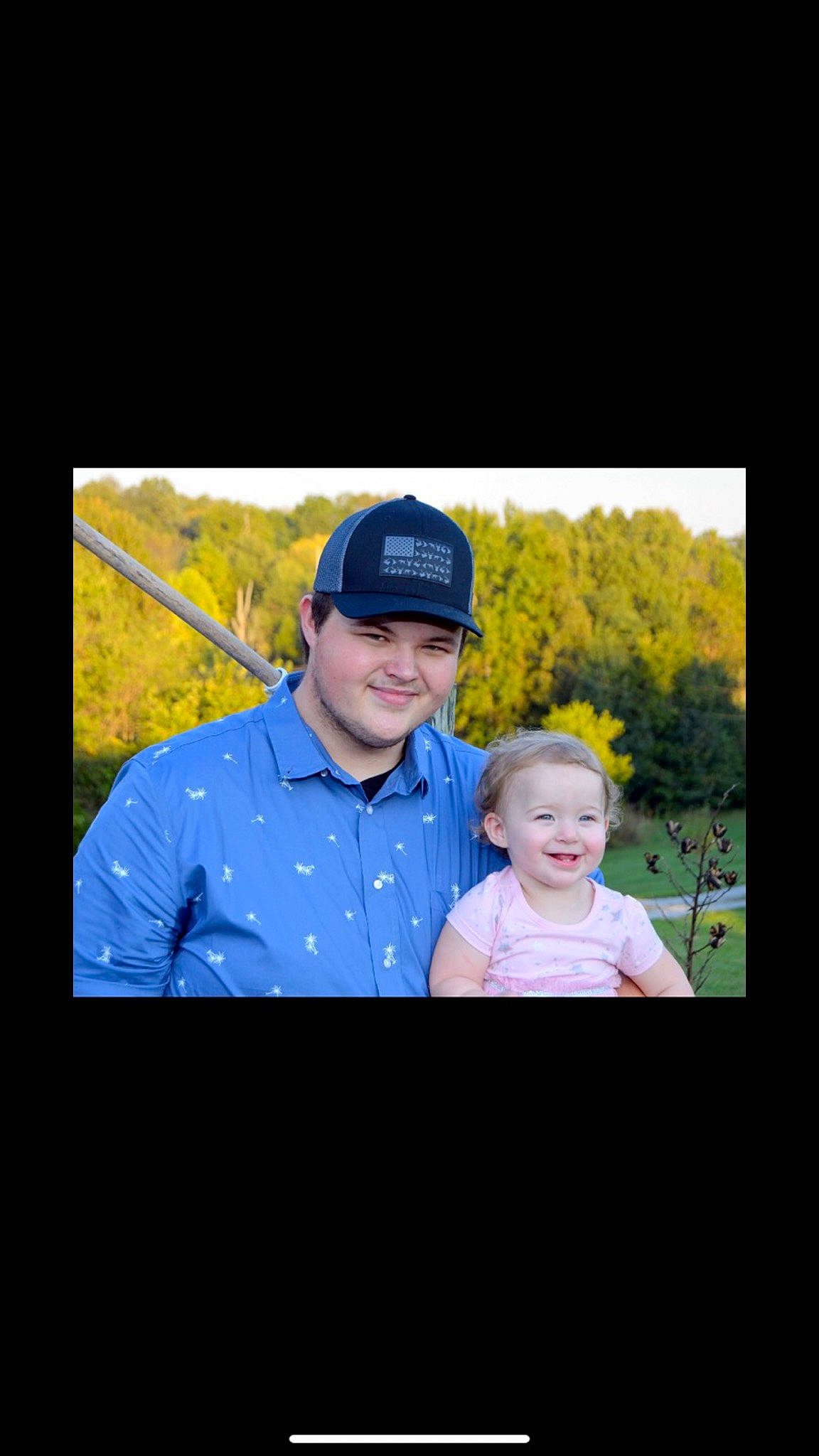 Veronica is registered to the contest to win money with this photo: baby, baseball_cap, cap, child, display_device, electric_blue, flash_photography, fun, gesture, grass, happy, headwear, joy, magenta, person, photo_caption, portrait_photography, recreation, sleeve, smile