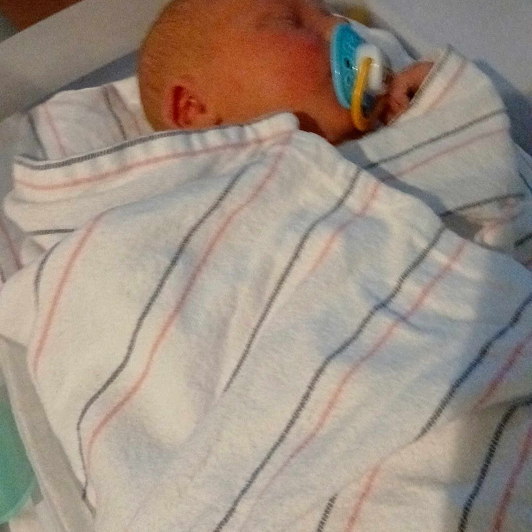 Hunter Wright joined the competition — help win amazing prizes! newborn, baby, pacifier, blanket, swaddled, sleeping, hospital_bassinet, infant, striped_blanket, cute, human, child, bed, resting, peaceful, indoors, person, small, wrapped, toddler