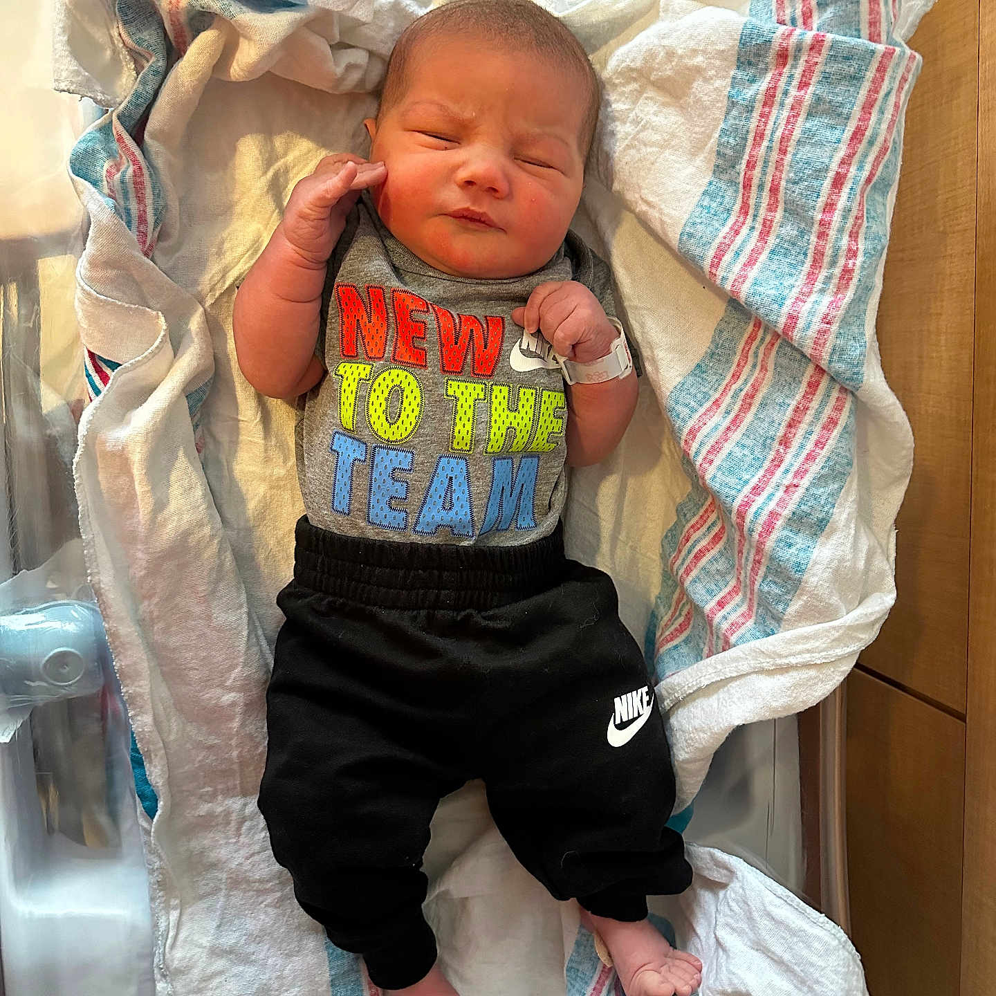 Colton joined the competition — help win amazing prizes! architecture, baby, bed, blanket, bodypart, building, clothing, crib, face, finger, furniture, head, hospital, infantbed, newborn, pants, person, photography, portrait, sleeping