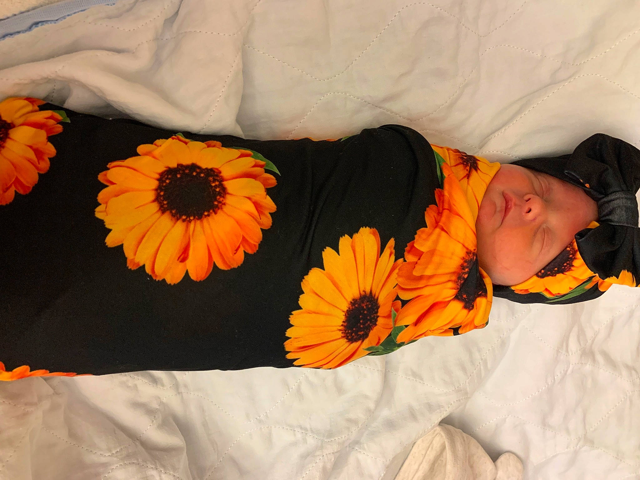 Devona is registered to the contest to win money with this photo: baby, beauty, bed, bedding, bedroom, comfort, flower, linens, orange, pattern, peach, person, petal, plant, product, rectangle, room, sunflower, t_shirt, textile