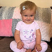 Marlee Rose is registered to the contest to win money with this photo: toddler, child, smiling, pink_clothing, butterflies, cross_legged, hair_bow, couch, pillows, fluffy, indoor, happy, cute, baby, sitting, portrait, cozy, young_child, playful, face