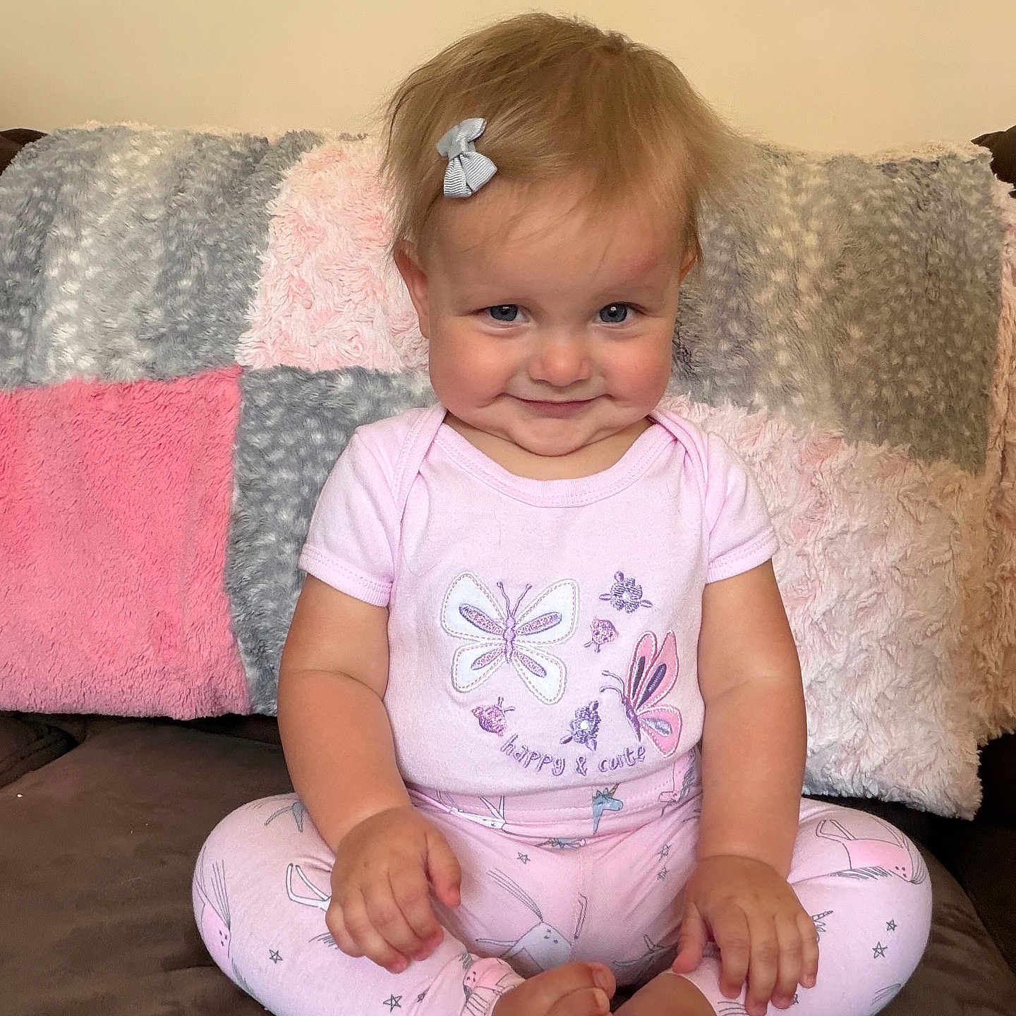 Marlee Rose is registered to the contest to win money with this photo: toddler, child, smiling, pink_clothing, butterflies, cross_legged, hair_bow, couch, pillows, fluffy, indoor, happy, cute, baby, sitting, portrait, cozy, young_child, playful, face
