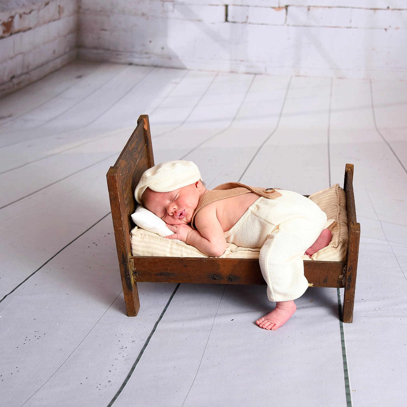 Desi is registered to the contest to win money with this photo: baby, bed, blanket, clothing, cradle, crib, face, furniture, hat, head, infantbed, newborn, person, sleeping, wood