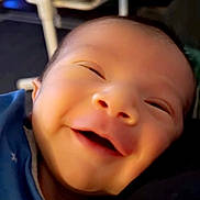 Ezra joined the competition — help win amazing prizes! baby, smiling, close_up, face, infant, blue_clothing, happy, indoor, person, cute, young_child, portrait, newborn, expression, head, skin, baby_clothes, joy, human, soft_light