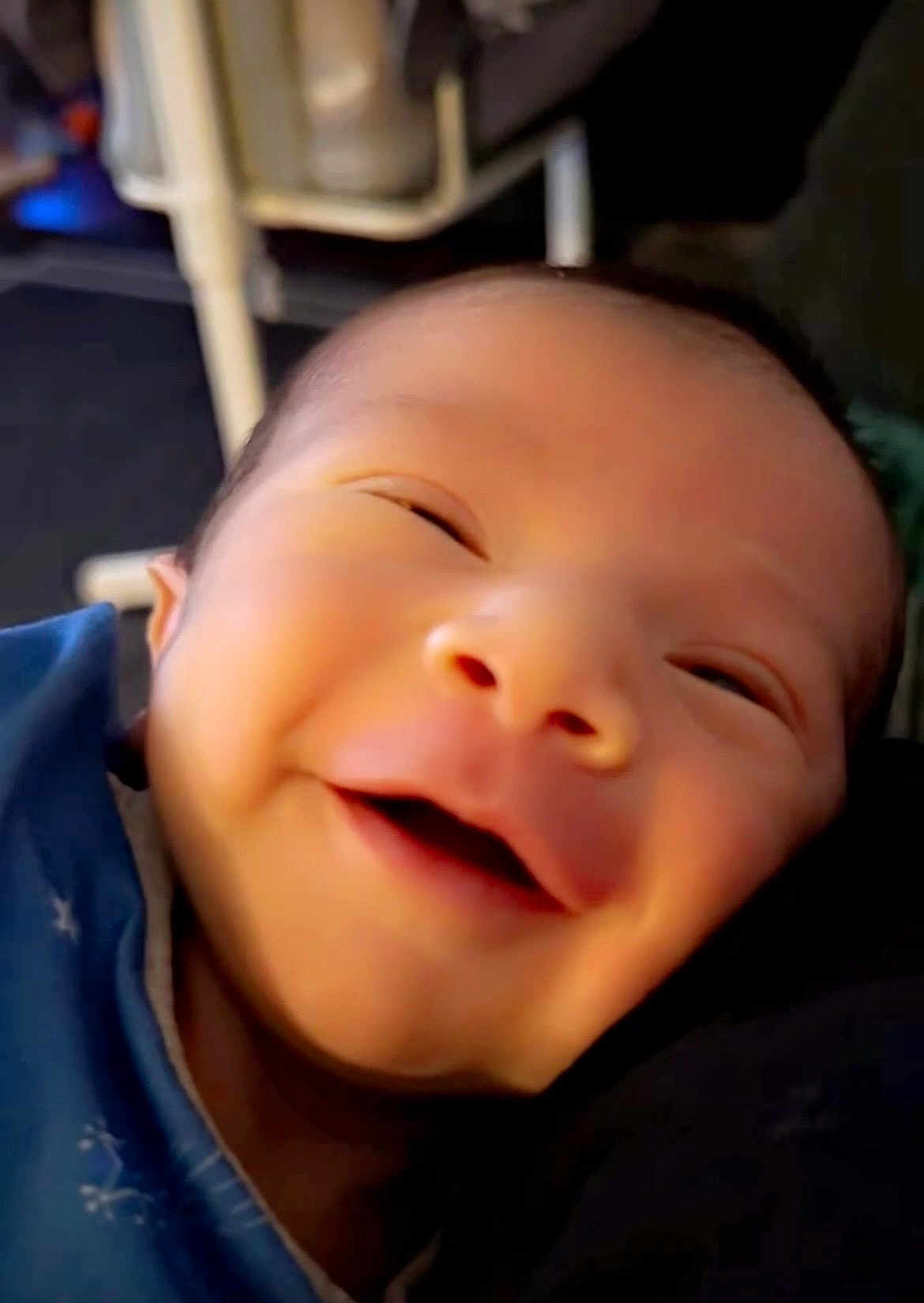 Ezra joined the competition — help win amazing prizes! baby, smiling, close_up, face, infant, blue_clothing, happy, indoor, person, cute, young_child, portrait, newborn, expression, head, skin, baby_clothes, joy, human, soft_light