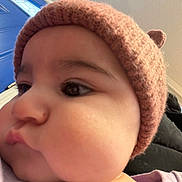 Semaj joined the competition — help win amazing prizes! baby, child, face, closeup, hat, knit_hat, pink, cheeks, indoor, door, blue, person, curious, warm_clothing, portrait, headwear, infant, young_child, cozy, looking_away