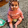 Semaj is registered to the contest to win money with this photo: baby, child, infant, pink_hoodie, headband, leopard_print, bow, carpet, floor, sitting, smiling, cute, indoor, happy, person, diaper, clothing, face, eyes, portrait