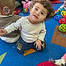Roman joined the competition — help win amazing prizes! child, toddler, curly_hair, sitting, carpet, toys, bubbles, playroom, colorful, indoor, kids, happy, casual_clothing, blue_pants, white_shirt, people, footwear, play, fun, curiosity