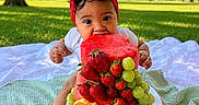 Alma joined the competition — help win amazing prizes! baby, child, infant, portrait, outdoor, park, picnic, blanket, fruit_cake, strawberries, grapes, oranges, fruit, red_bow, headband, white_shirt, sitting, smiling, birthday, greenery