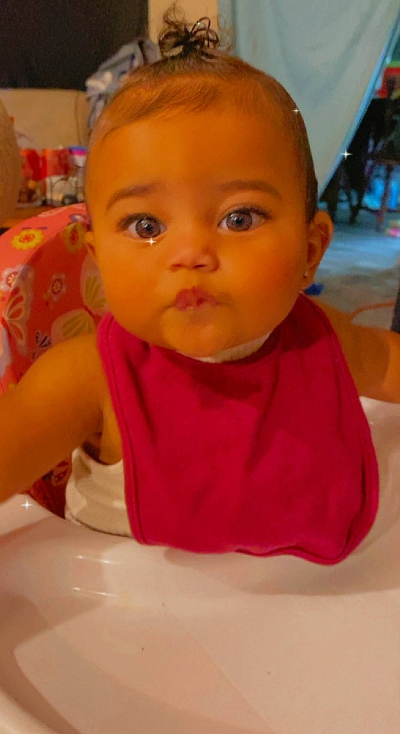 Kiara joined the competition — help win amazing prizes! baby, bib, cheek, child, close_up, ear, eye, eyebrow, eyelash, finger, food, forehead, happy, iris, lip, mouth, nose, person, skin, tableware
