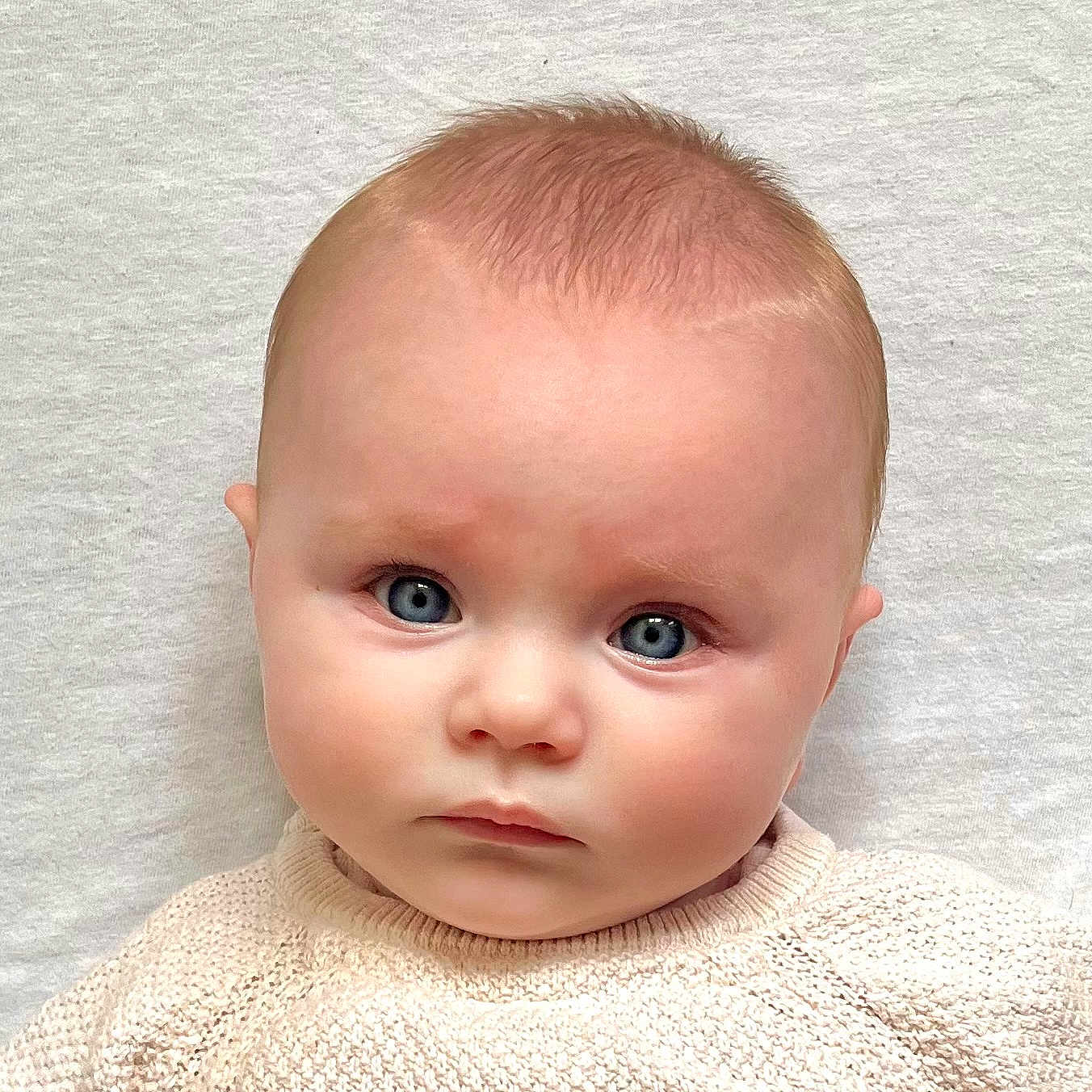Brooke is registered to the contest to win money with this photo: baby, blonde, clothing, face, hair, head, knitwear, newborn, person, photography, portrait, sitting, skin, sleeve, sweater