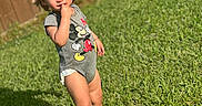 Colton is registered to the contest to win money with this photo: barefoot, casual, child, cute, daylight, expression, fence, grass, mickey_mouse, nature, onesie, outdoor, person, playful, portrait, standing, summer, sunlight, toddler, young_child