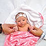 baby, newborn, infant, blanket, pink, headband, bow, hands, adult, bracelets, hospital_wristband, skin, white_background, bed, holding_hands, cute, portrait, wrapped, small, human
