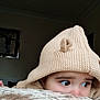Syed Masoom is registered to the contest to win money with this photo: child, toddler, face, eyes, hat, knit_hat, beige, cozy, plush, blanket, indoor, curious, peeking, soft_texture, portrait, closeup, person, warm_clothing, cute, expression
