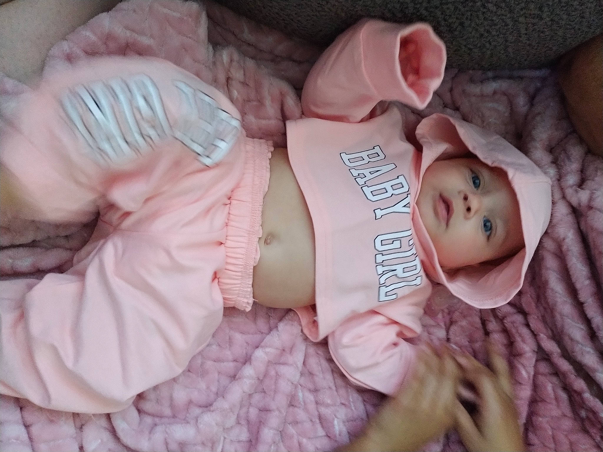 Maliah is registered to the contest to win money with this photo: arm, baby, baby_products, baby_toddler_clothing, cheek, comfort, eye, finger, head, headwear, human_body, leg, linens, lip, mouth, nail, person, pink, skin, sleeve