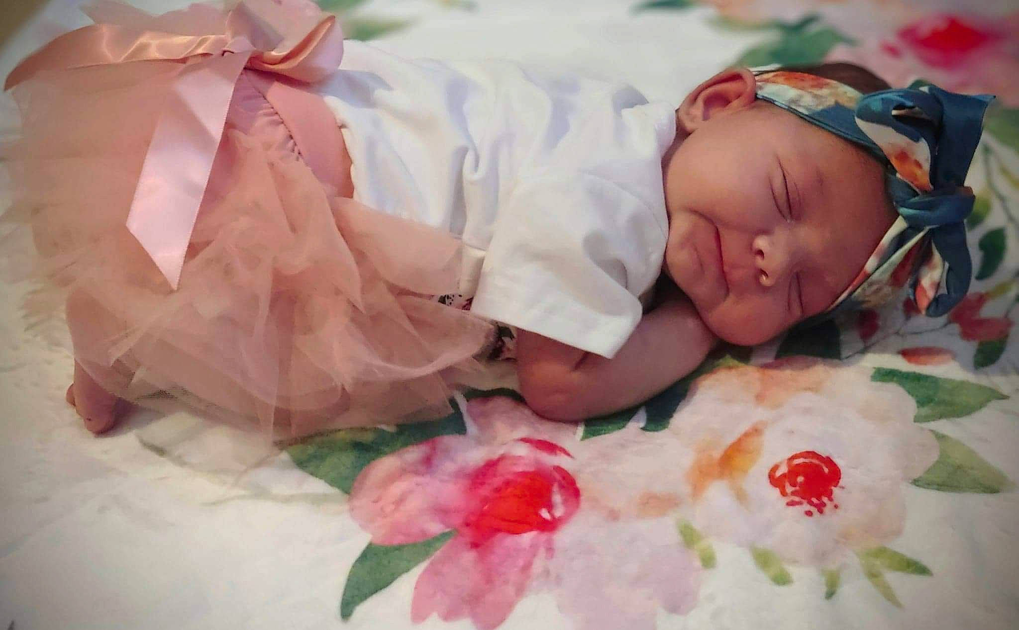 Aria is registered to the contest to win money with this photo: baby, child, flower, hair_accessory, headwear, person, petal, pink, plant, sweetness, toddler