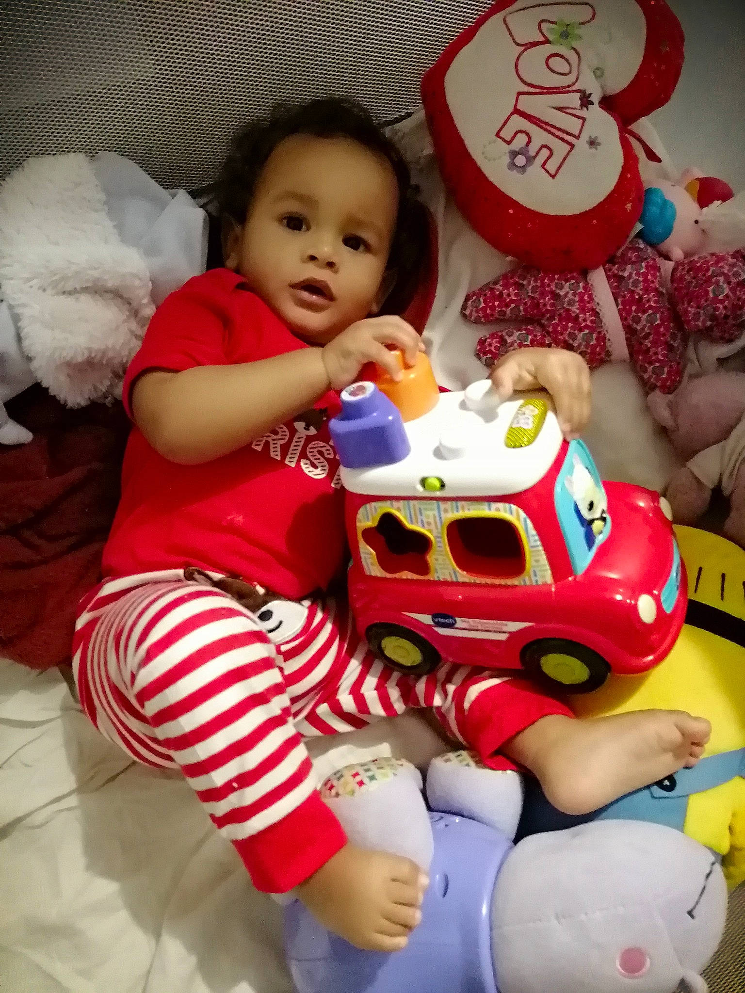 Noah participe au concours pour gagner de l'argent avec cette photo : arm, baby, baby_toddler_clothing, carmine, cheek, child, comfort, event, fun, happy, holiday, lap, person, pink, red, sitting, skin, sock, textile, toddler