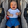 baby, smiling, stroller, white_shirt, blue_shorts, plush_toy, child, happy, infant, seatbelt, outdoor, sunlight, cute, young_child, clothing, person, legs, head, hands, comfort