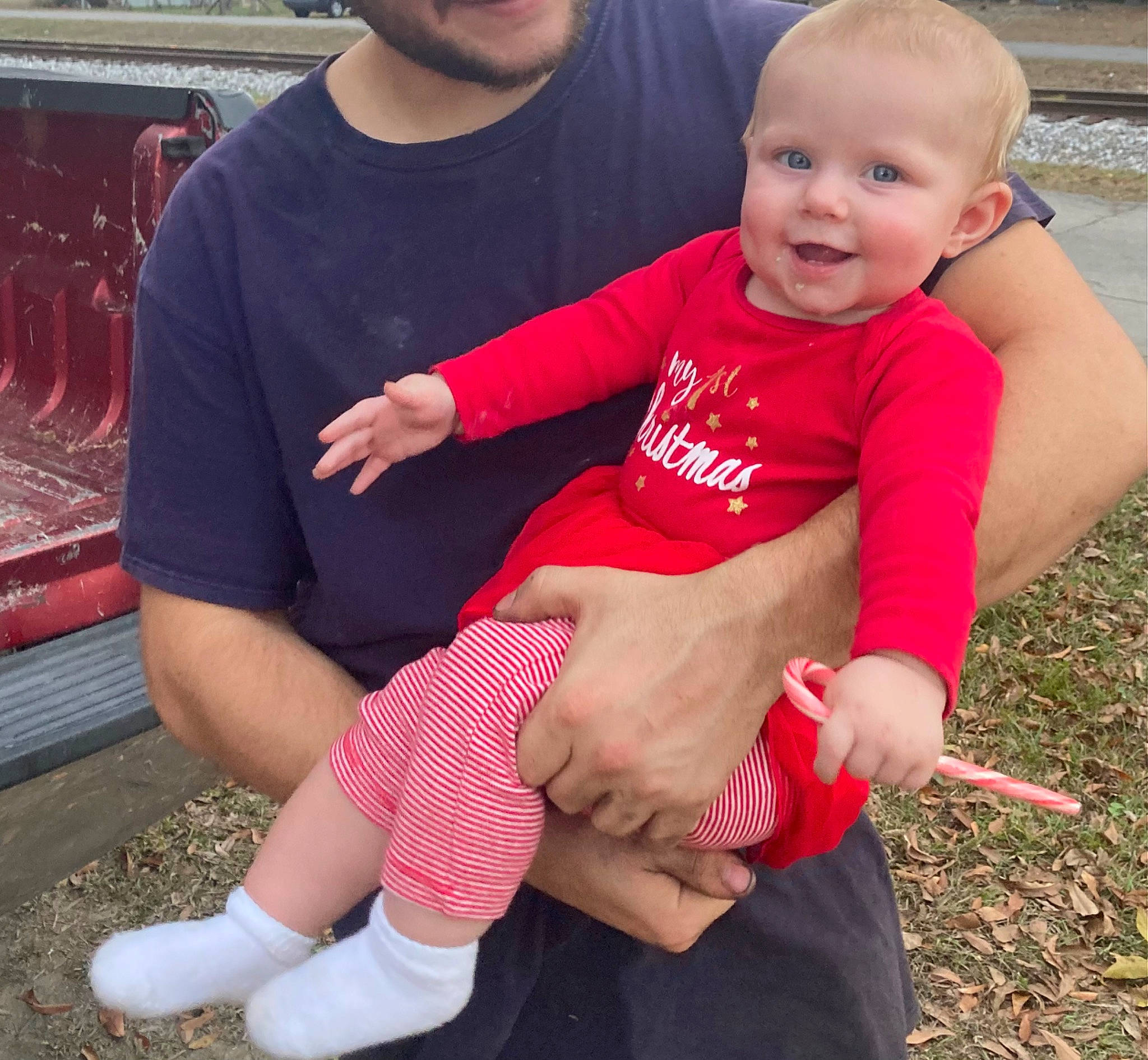 Aubree is registered to the contest to win money with this photo: baby, baby_toddler_clothing, finger, fun, grass, happy, joy, knee, lap, leg, leisure, muscle, person, pink, red, shorts, shoulder, sleeve, t_shirt, thigh